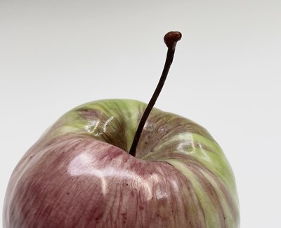 Lot 956 - A porcelain sculpture of an apple modelled by...