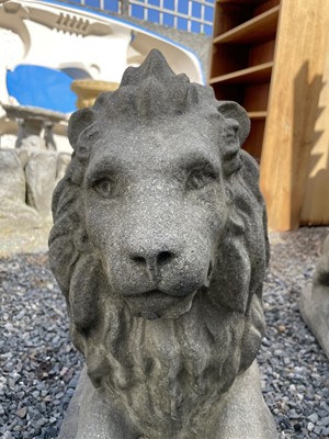 Lot 650 - A large pair of reconstituted stone recumbent...