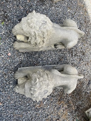 Lot 650 - A large pair of reconstituted stone recumbent...
