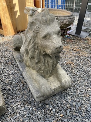 Lot 650 - A large pair of reconstituted stone recumbent...