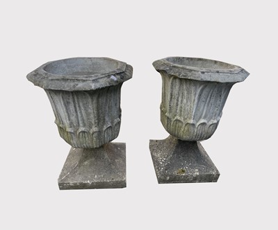 Lot 644 - A pair of reconstituted stone garden urns of...