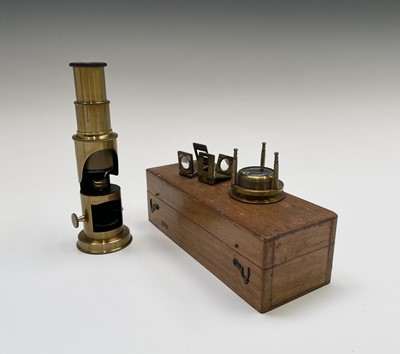 Lot 562 - A brass students microscope, in wooden case,...