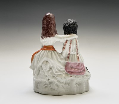 Lot 968 - A Staffordshire figure of Topsy and Eva, circa...