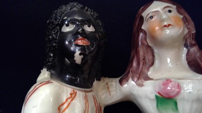 Lot 968 - A Staffordshire figure of Topsy and Eva, circa...