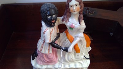 Lot 968 - A Staffordshire figure of Topsy and Eva, circa...