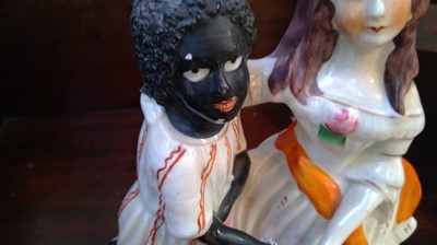 Lot 968 - A Staffordshire figure of Topsy and Eva, circa...