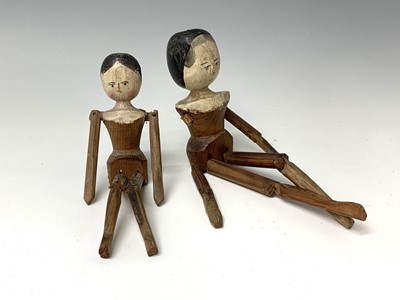 Lot 329 - Two carved wood and painted peg dolls, length...