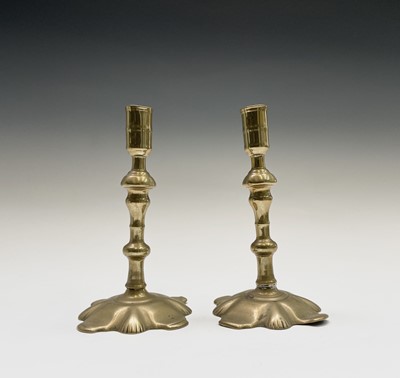 Lot 158 - A pair of George III petal base brass...
