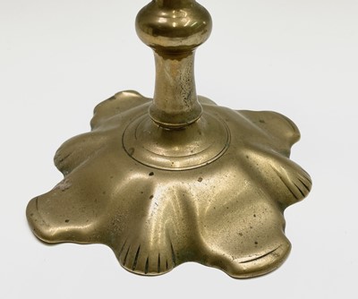 Lot 158 - A pair of George III petal base brass...