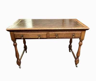 Lot 211 - An Edwardian oak writing table, the...