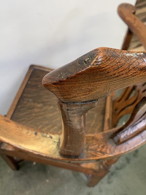 Lot 197 - A George III oak corner armchair, with...