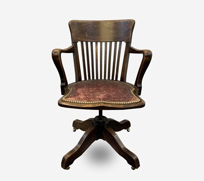 Lot 209 - An Edwardian oak swivel armchair, height 85cm,...