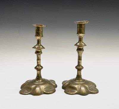 Lot 160 - A pair of George III petal base brass...