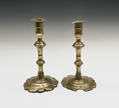 Lot 161 - A pair of George III petal base brass...