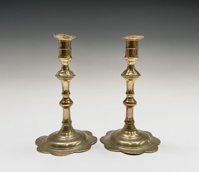Lot 162 - A pair of George III petal base brass...