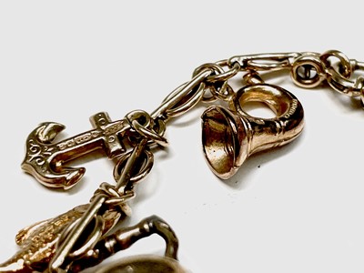 Lot 110 - A 9ct gold charm bracelet with some 19 charms...