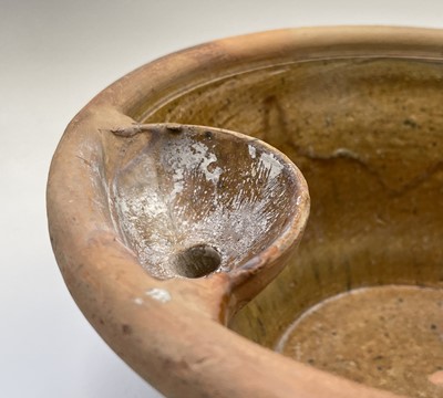 Lot 529 - A terracotta farming pan, with glazed interior...