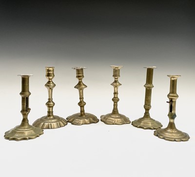 Lot 106 - Six George III petal base brass candlesticks,...