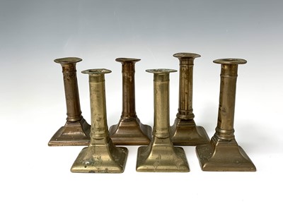 Lot 128 - Three pairs of 18th century brass candlesticks,...