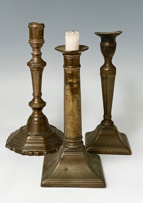 Lot 127 - Four pairs of brass candlesticks, 18th and...
