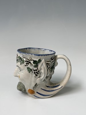 Lot 110 - An English pearlware satyr jug, early 19th...