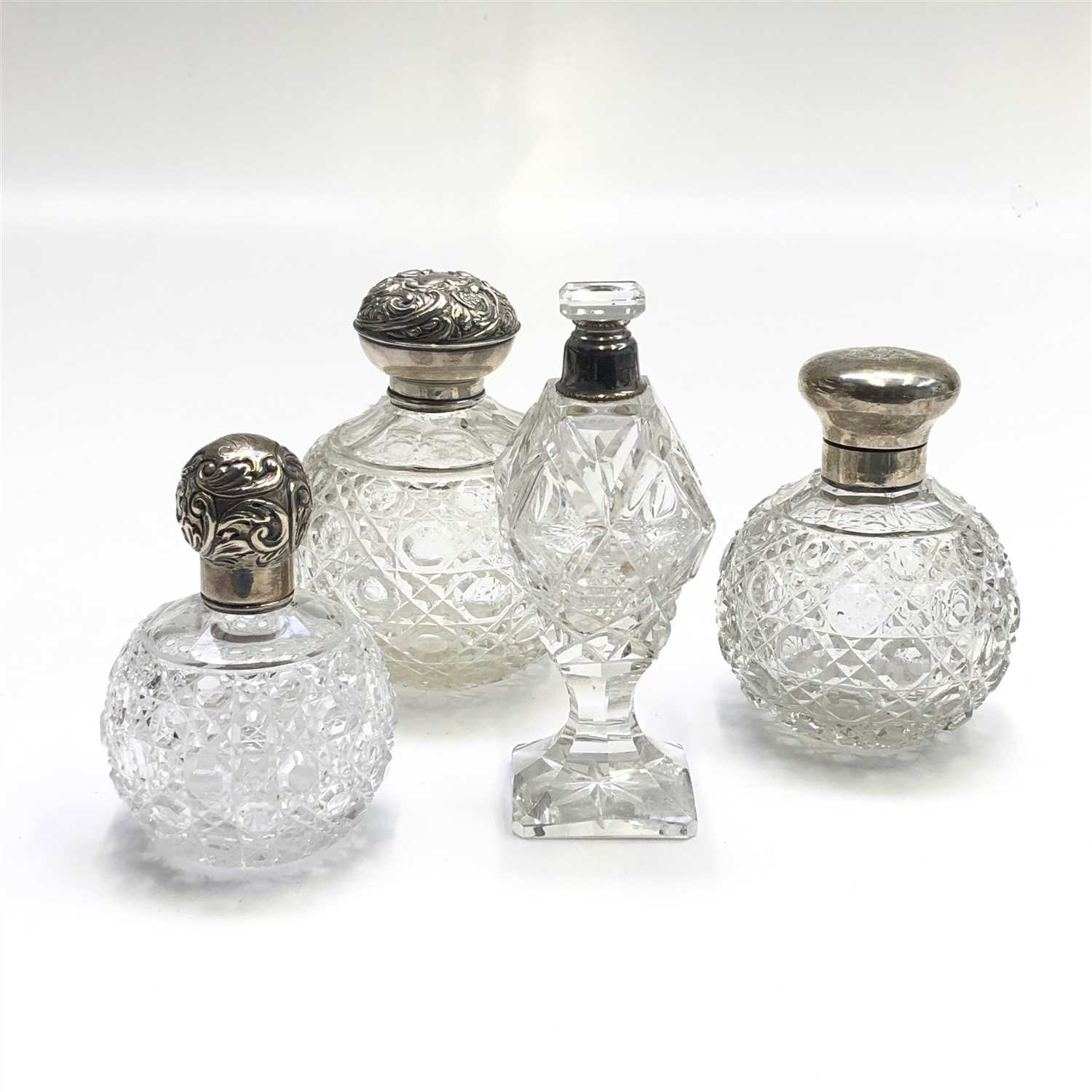 Lot 2046 - Three cut round glass toilet bottles with...