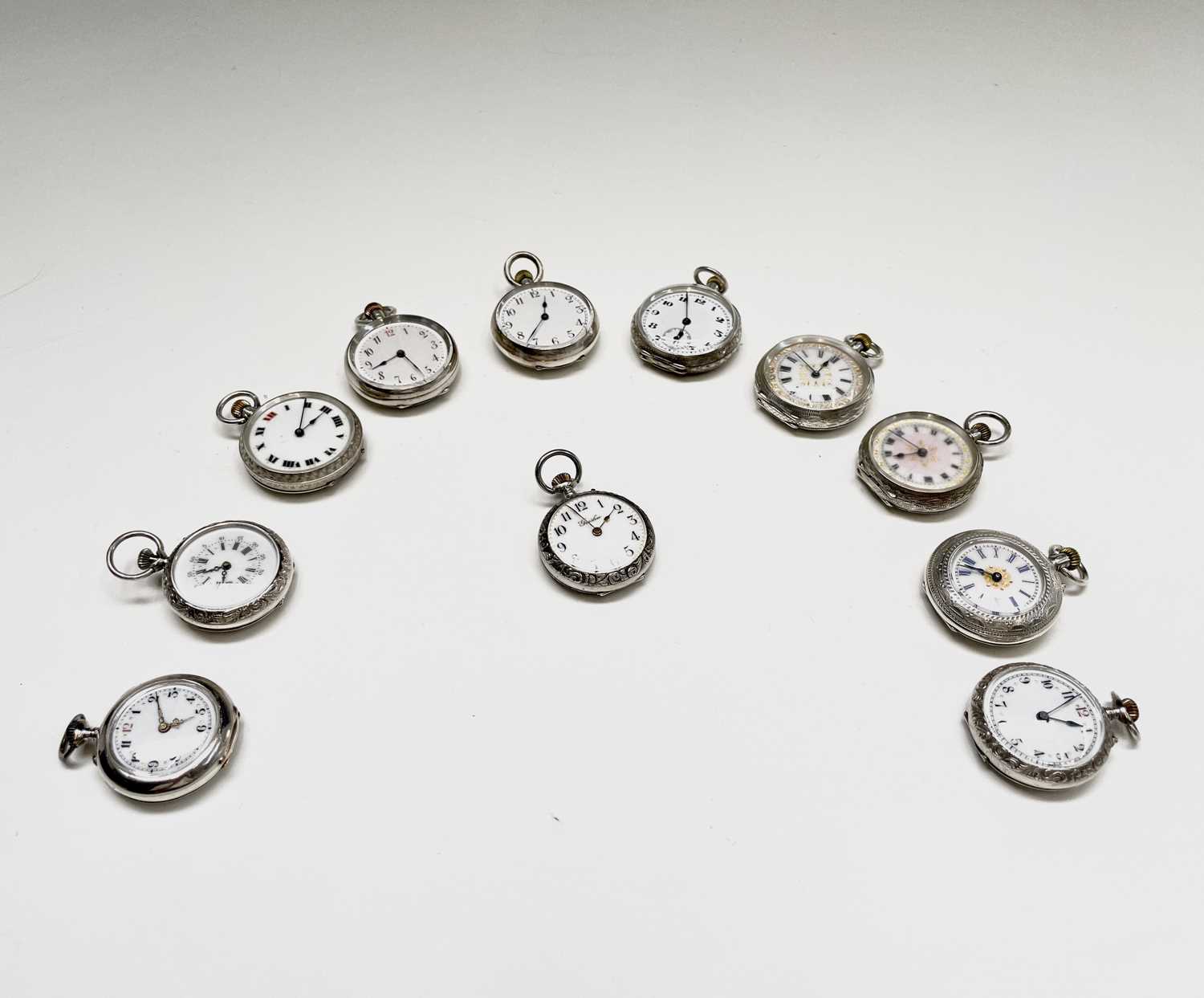 Lot 85 - Twelve small silver keyless fob watches, each...