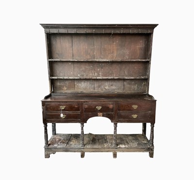 Lot 216 - A George III oak dresser, the rack with two...