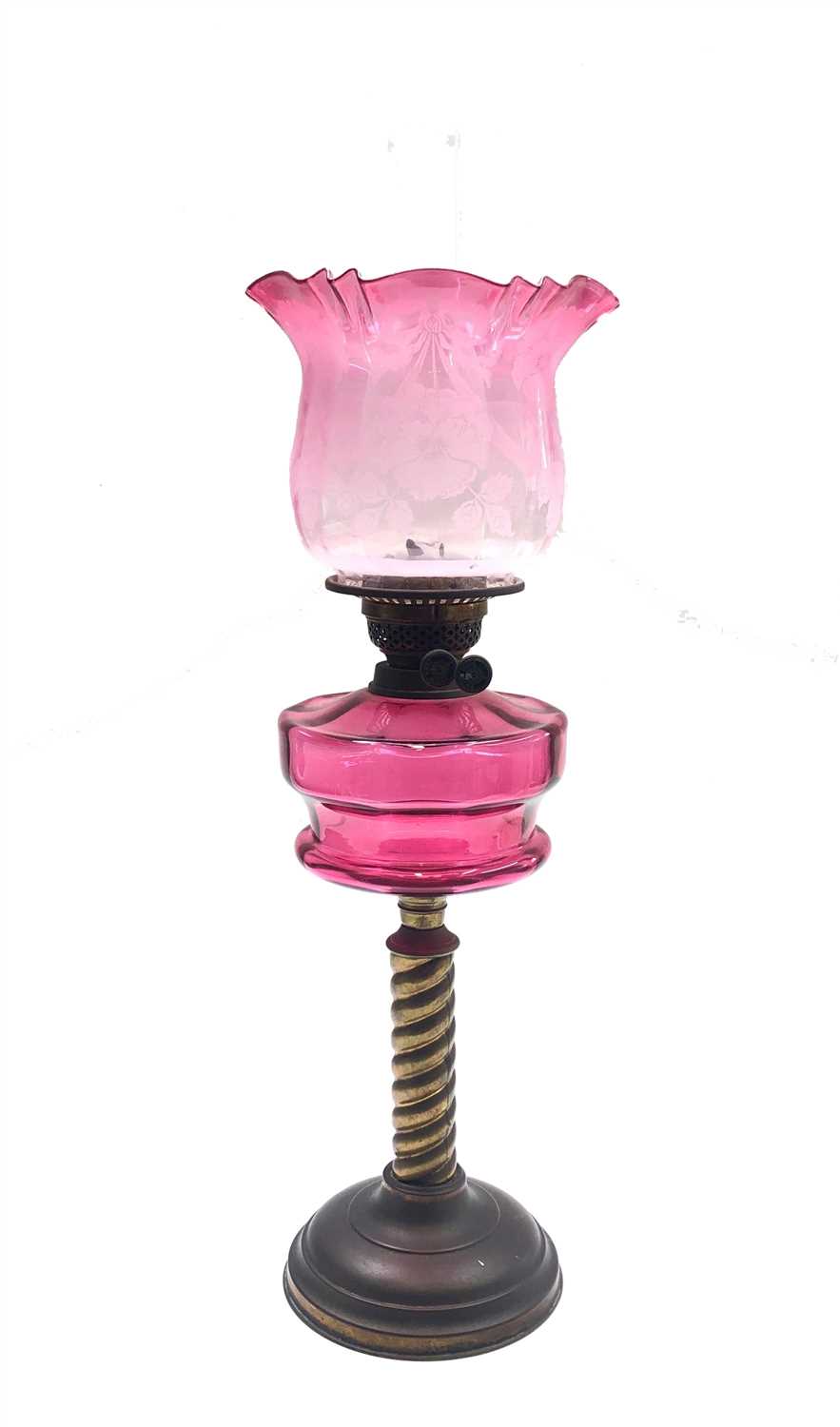Lot 1 - A brass and cranberry glass oil lamp, circa...