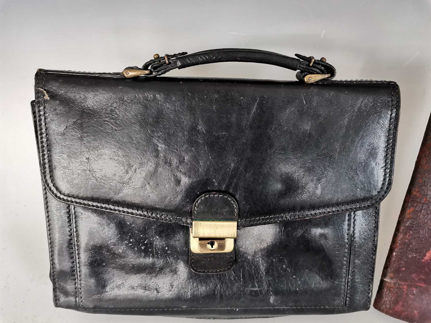 Lot 115 A black leather bag with a vintage leather