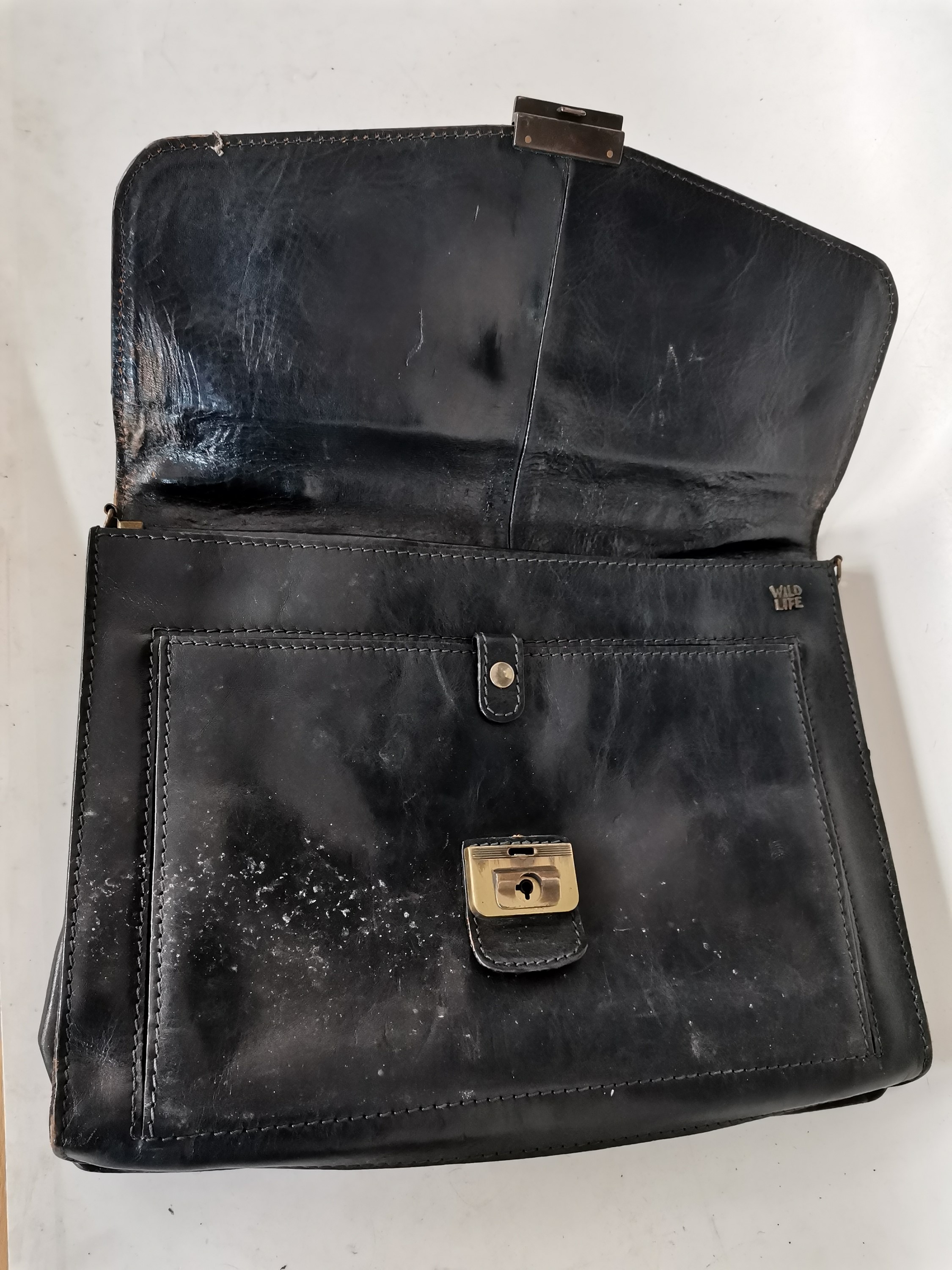 Lot 115 A black leather bag with a vintage leather