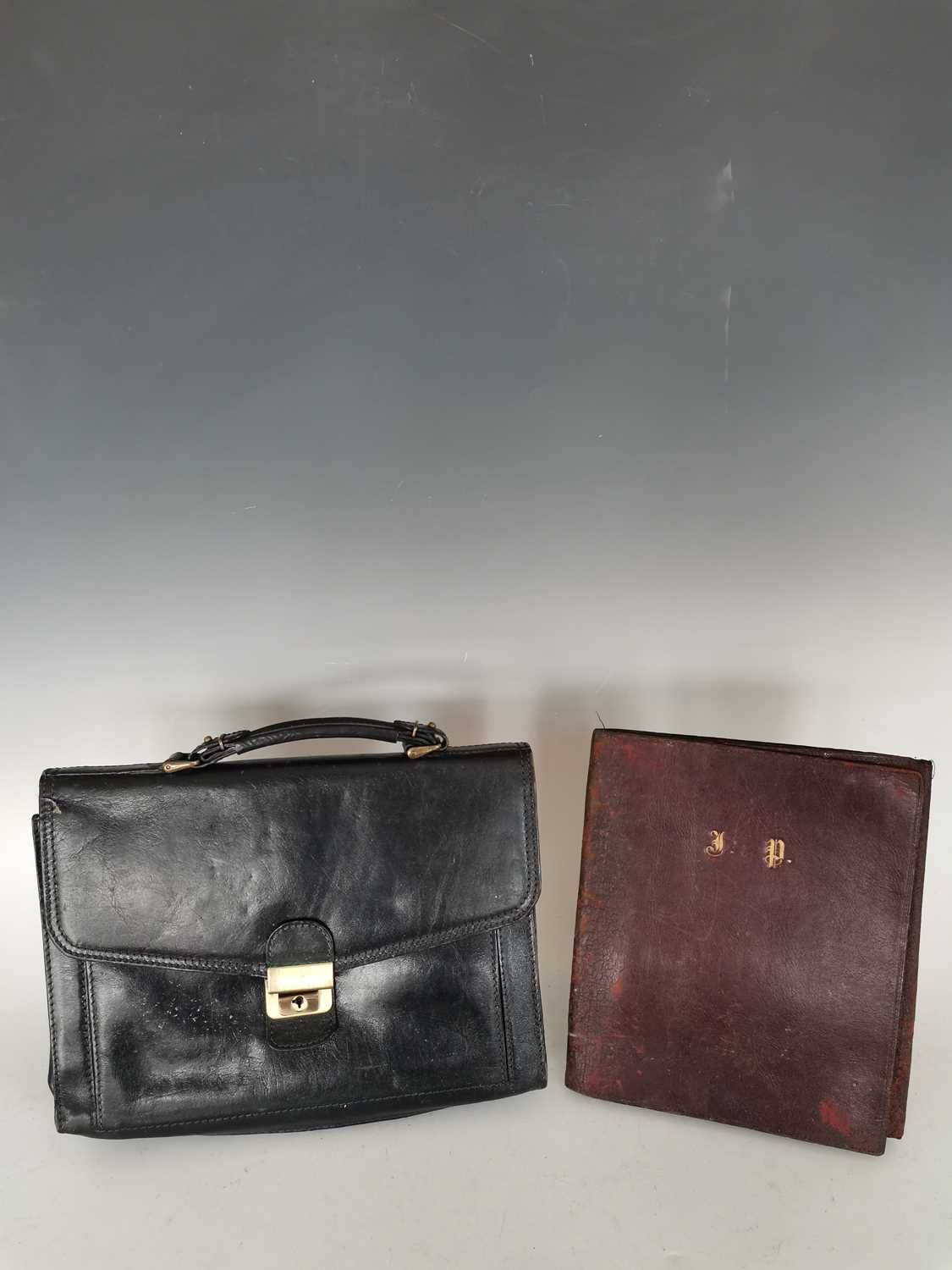 Lot 115 A black leather bag with a vintage leather