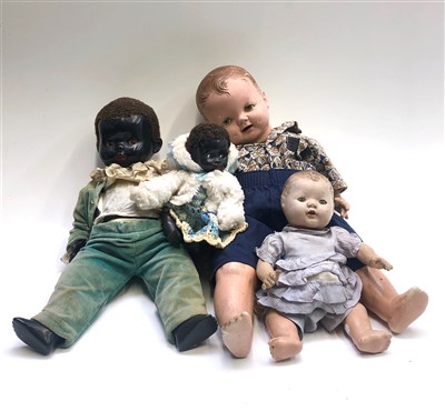 Lot 544 - A celluloid black boy doll, 50cm and three...