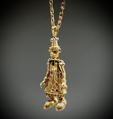 Lot 220 - A gold gem-set articulated clown pendant on...