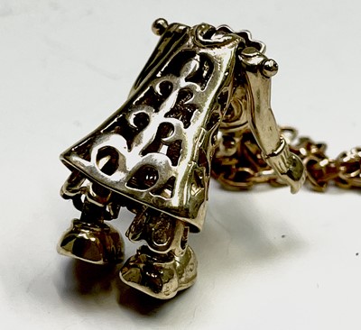Lot 220 - A gold gem-set articulated clown pendant on...