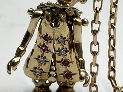 Lot 220 - A gold gem-set articulated clown pendant on...