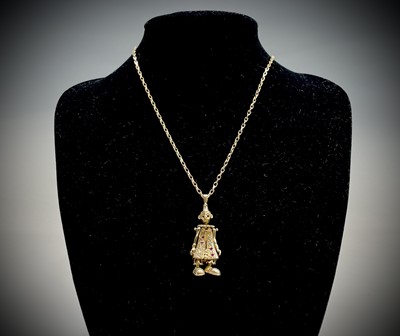Lot 220 - A gold gem-set articulated clown pendant on...