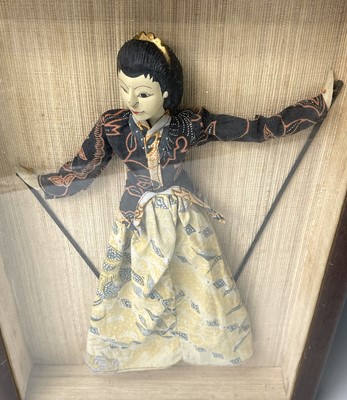 Lot 376 - An Indonesian doll, in a mahogany glazed...