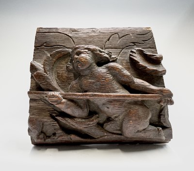 Lot 299 - An oak carving of a naked figure holding a...