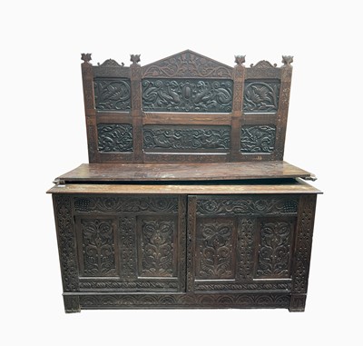 Lot 325 - An oak cupboard, with a carved back, the base...