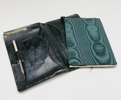 Lot 57 - An Edwardian black leather toilet case with...