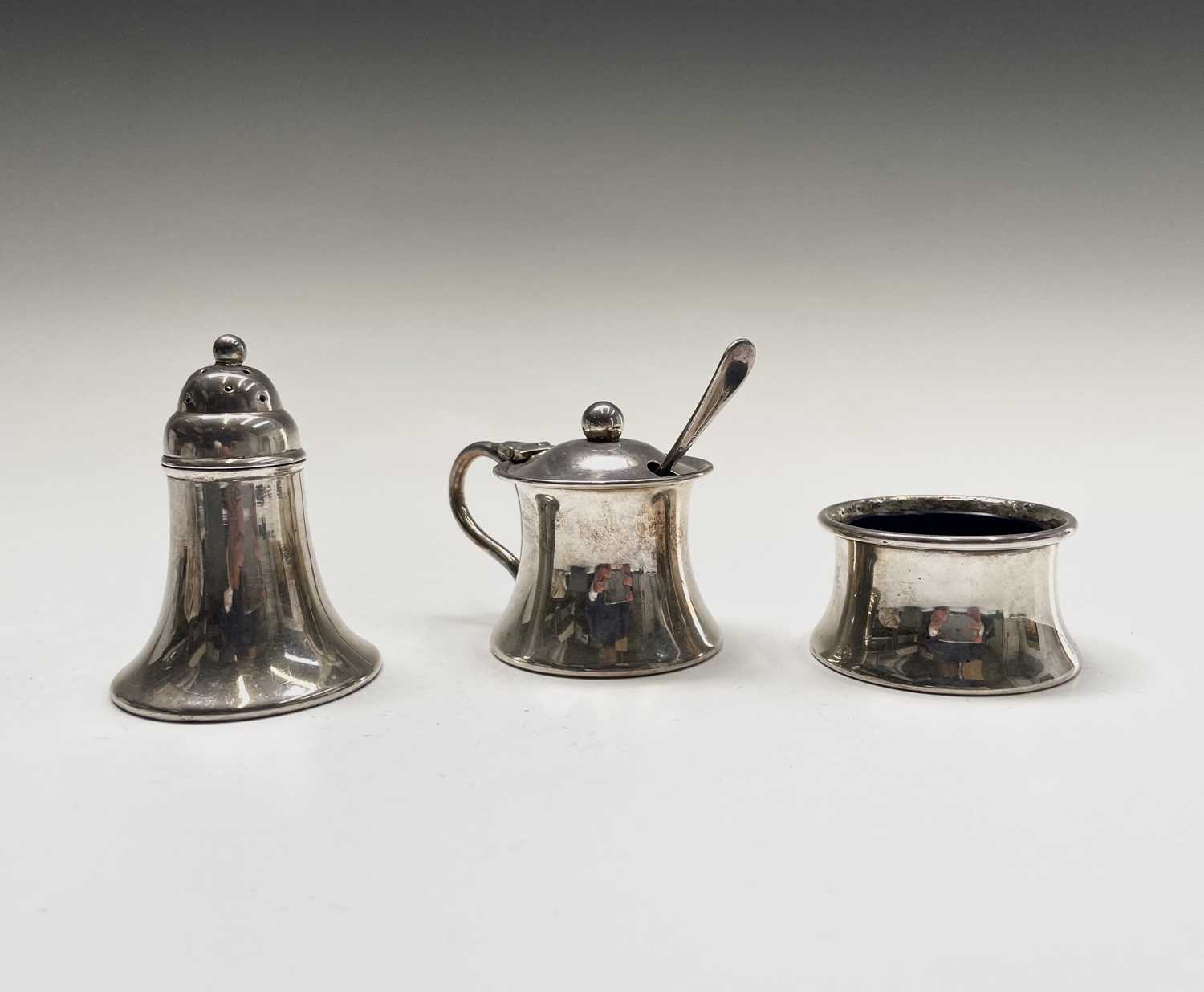 Lot 118 - A three-piece silver plated cruet set, each...