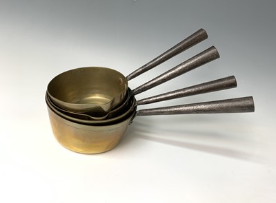 Lot 360 - Four Victorian brass saucepans, with iron...