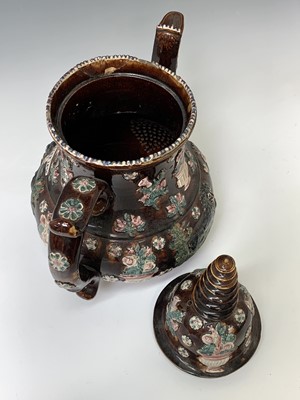Lot 815 - A Measham treacle glazed barge ware teapot,...