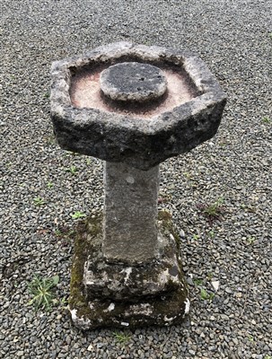 Lot 564 - A stone bird bath of octagonal shape, raised...