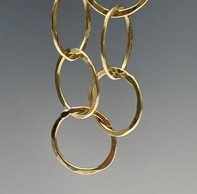 Lot 42 - A contemporary, artist made 18ct gold hammered...