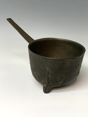 Lot 440 - A 17th century bronze skillet, the feet cast...