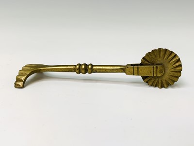 Lot 442 - An early 19th century brass pastry jigger,...