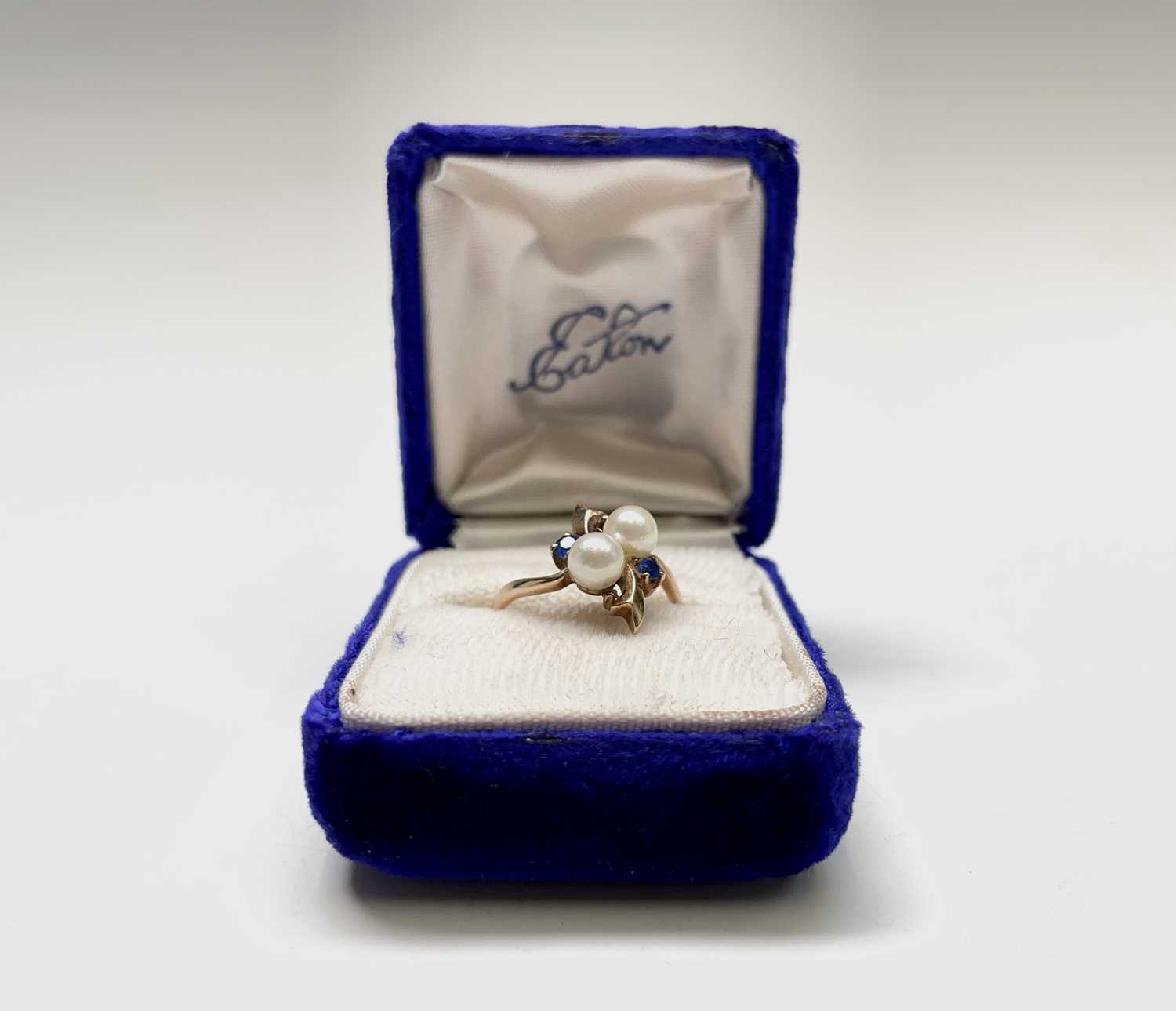 Lot 57 - A 10ct gold dress ring set with two pearls and...