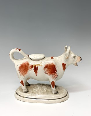 Lot 472 - A 19th century Staffordshire cow creamer,...